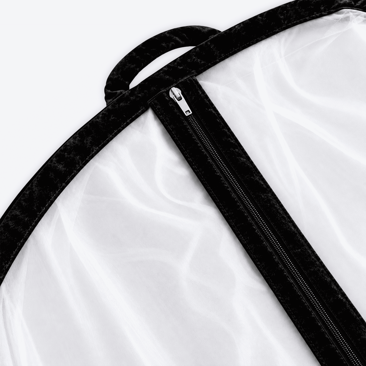 Close detail of the black velvet trim on a sheer organza garment cover