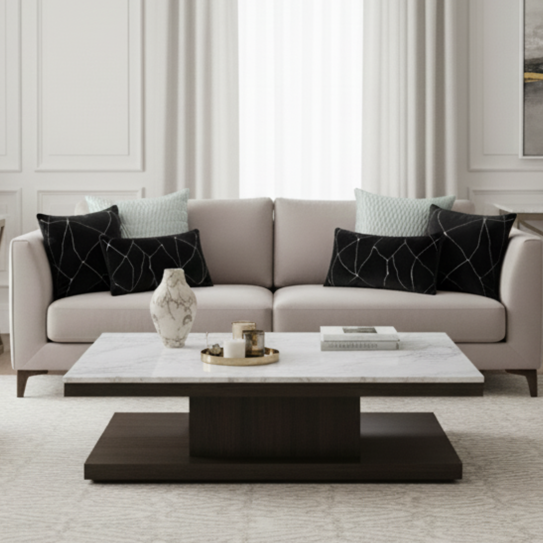 Modern living room with a beige sofa, decorative pillows, and a marble coffee table.