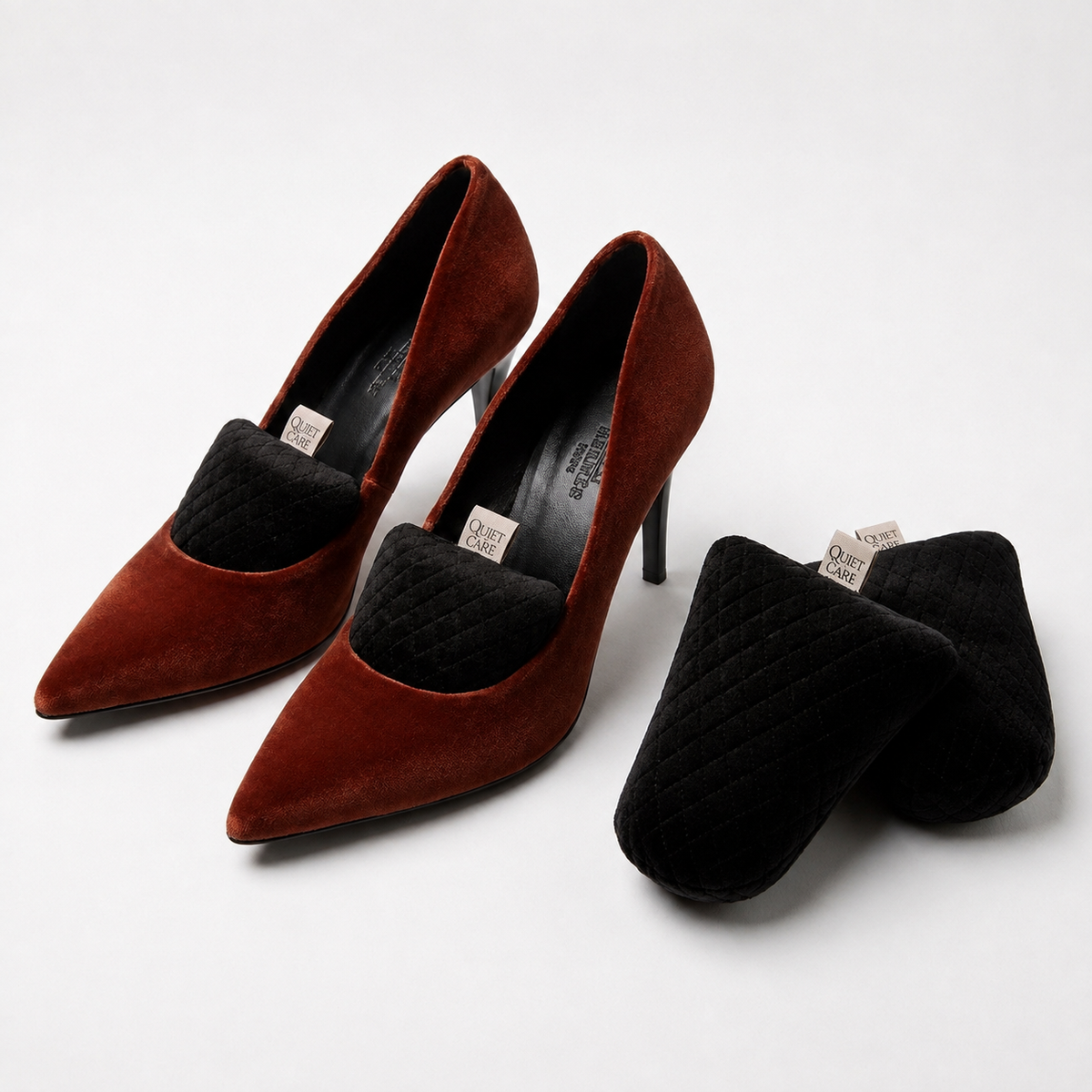 Quilted velvet shoe shapers in black shown beside shoes, for EU 40 to 44
