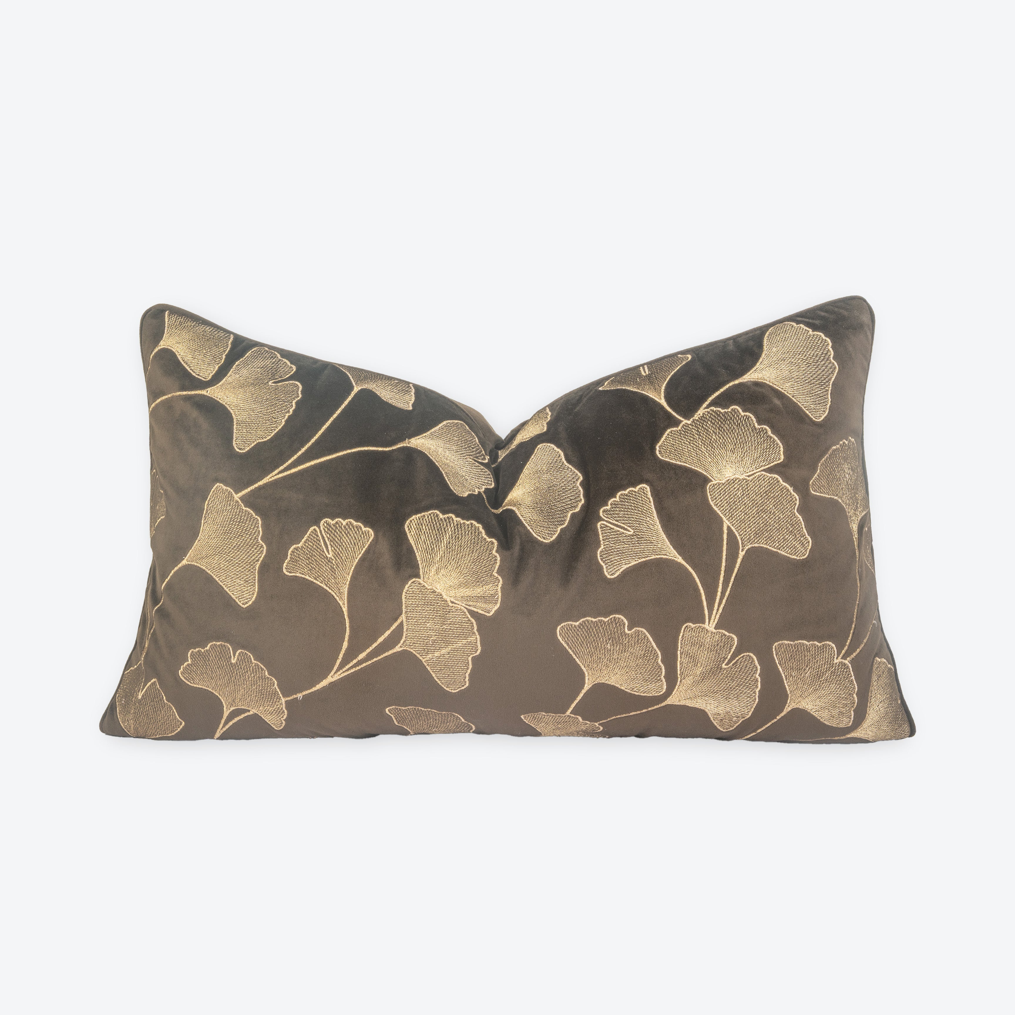 Decorative pillow with gold leaf pattern on a brown background