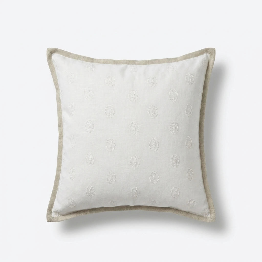 Ivory linen cushion with embroidered pineapple motifs and natural oatmeal flange border