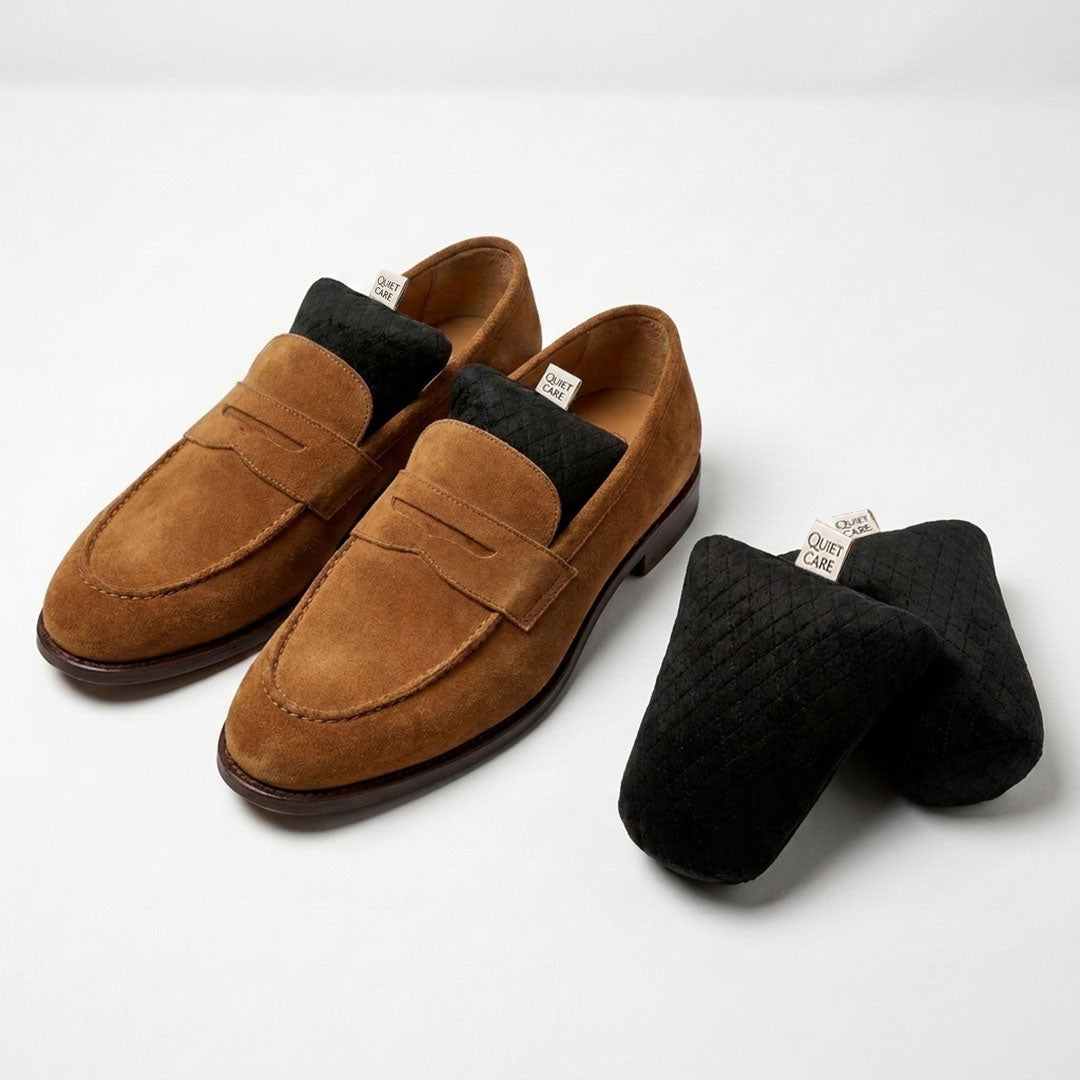 Quilted velvet shoe shapers in black shown beside shoes, for EU 35 to 39