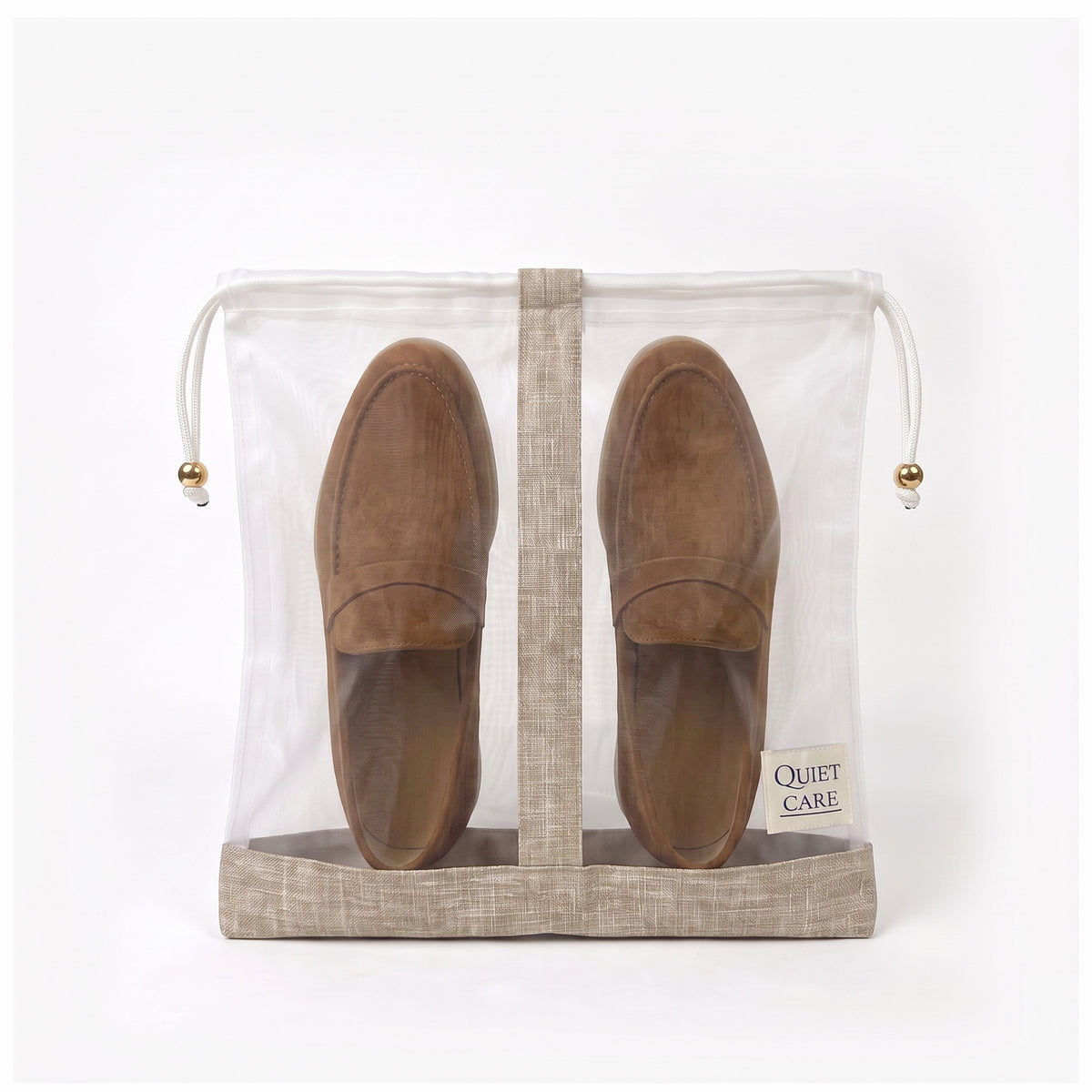 Sheer shoe bag with linen blend trim holding a pair of shoes, second angle