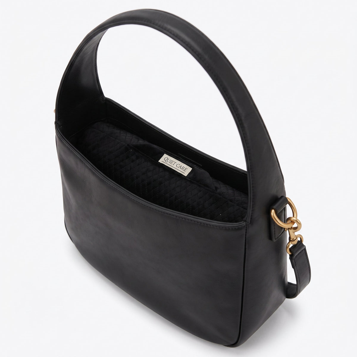 Slim quilted velvet bolster shaper shown inside a soft rounded bag