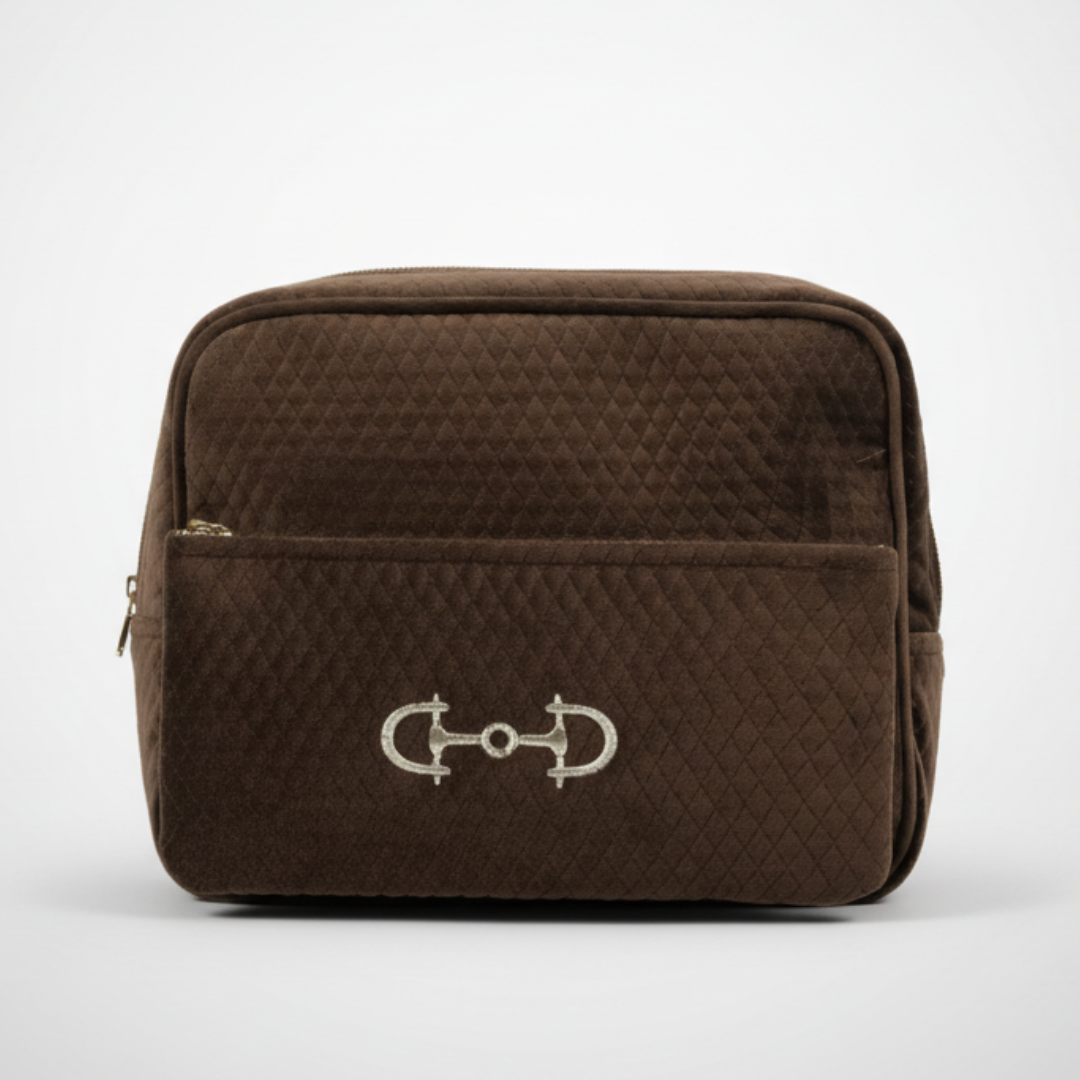 Brown quilted bag with a horse bit emblem on a white background
