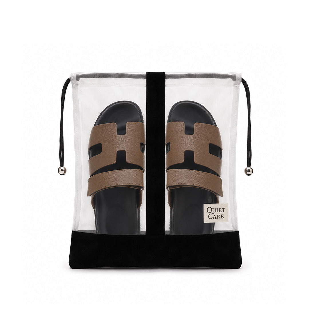 Sheer shoe bag with velvet trim holding a pair of sandals, each shoe kept apart