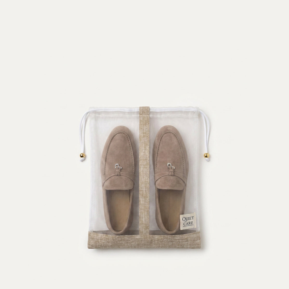 Sheer shoe bag with linen blend trim holding a pair of shoes, second angle