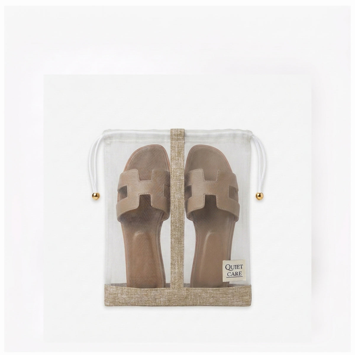 Sheer shoe bag with linen blend trim holding a pair of shoes, centre divider visible