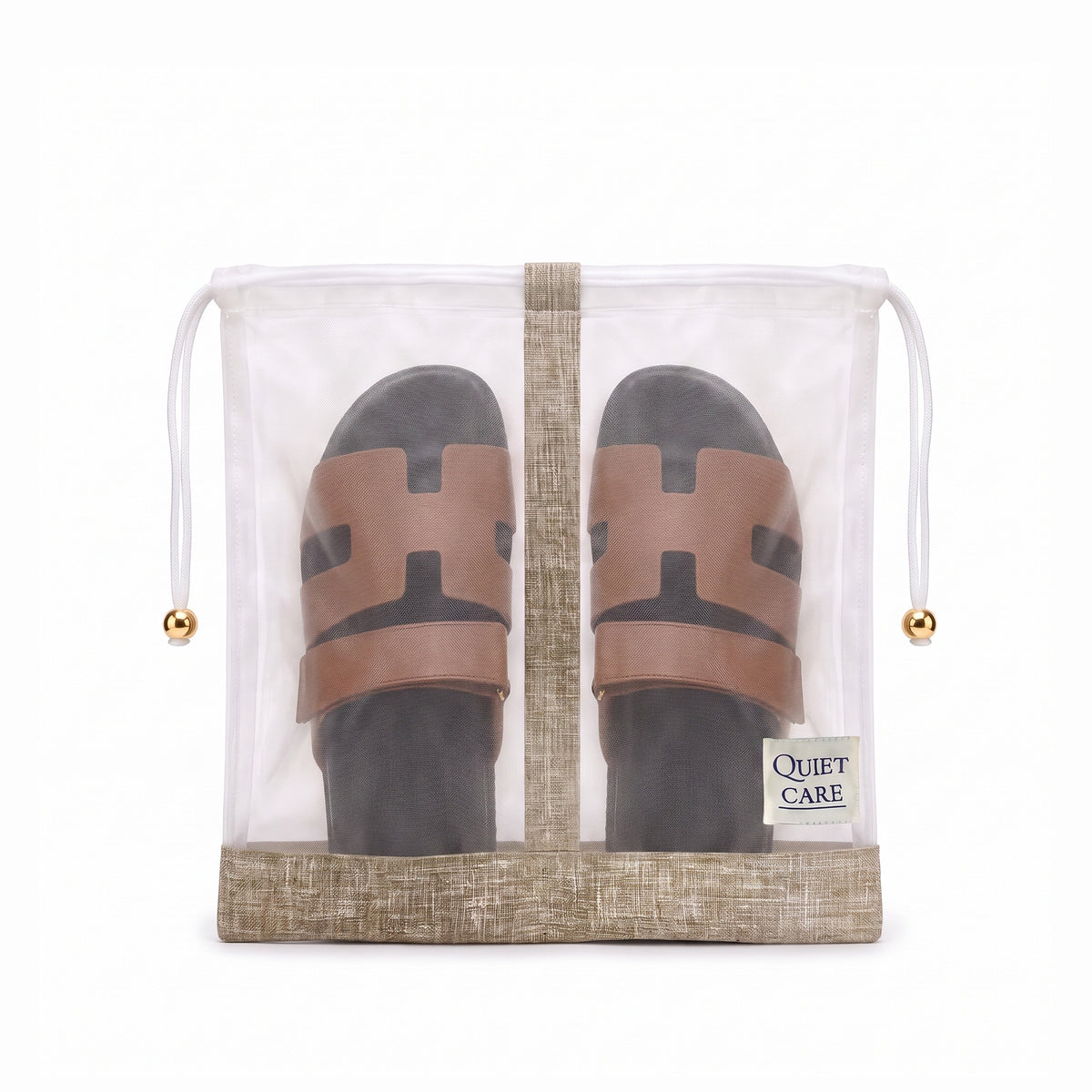 Sheer shoe bag with linen blend trim holding a pair of shoes, centre divider visible