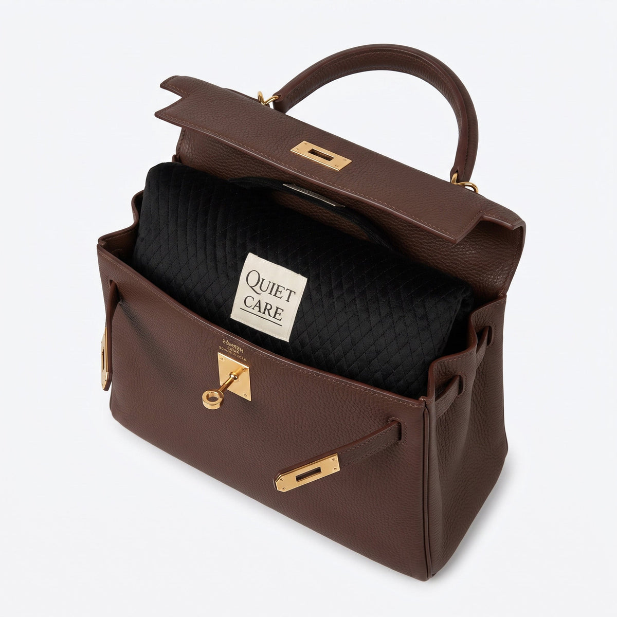 Quilted velvet bag shaper shown inside a tapered top-handle bag, holding the taper